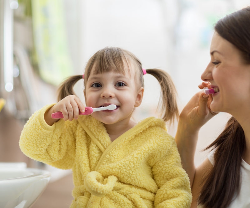 Young girl brushing her teeth.