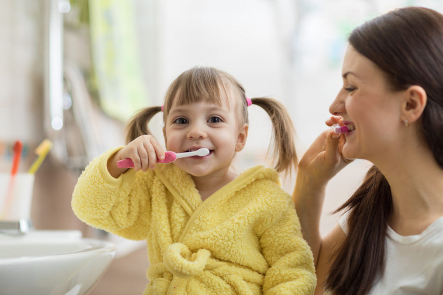 Young girl brushing her teeth.